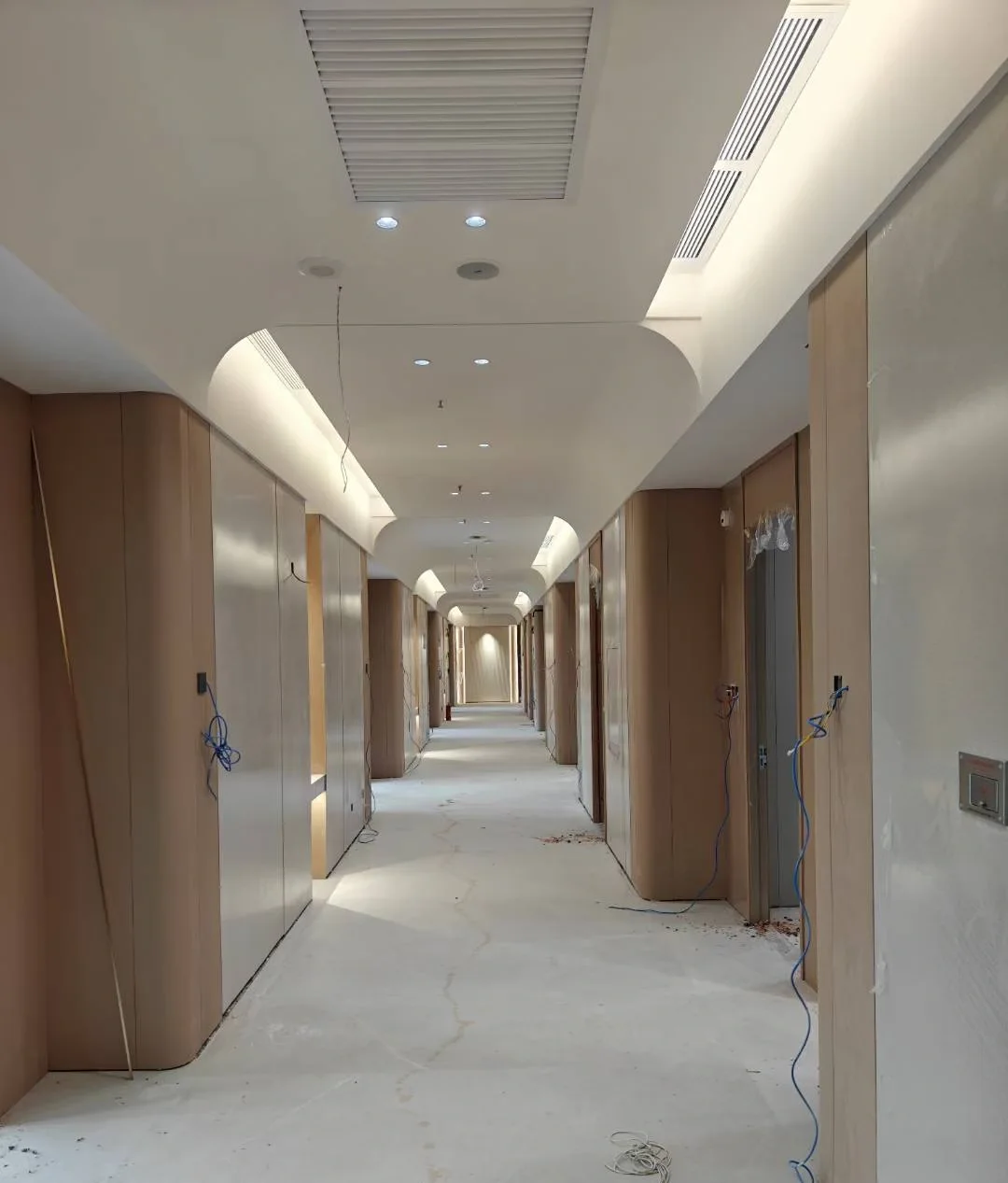 Corridor with curved ceiling and wood veneer wall panels