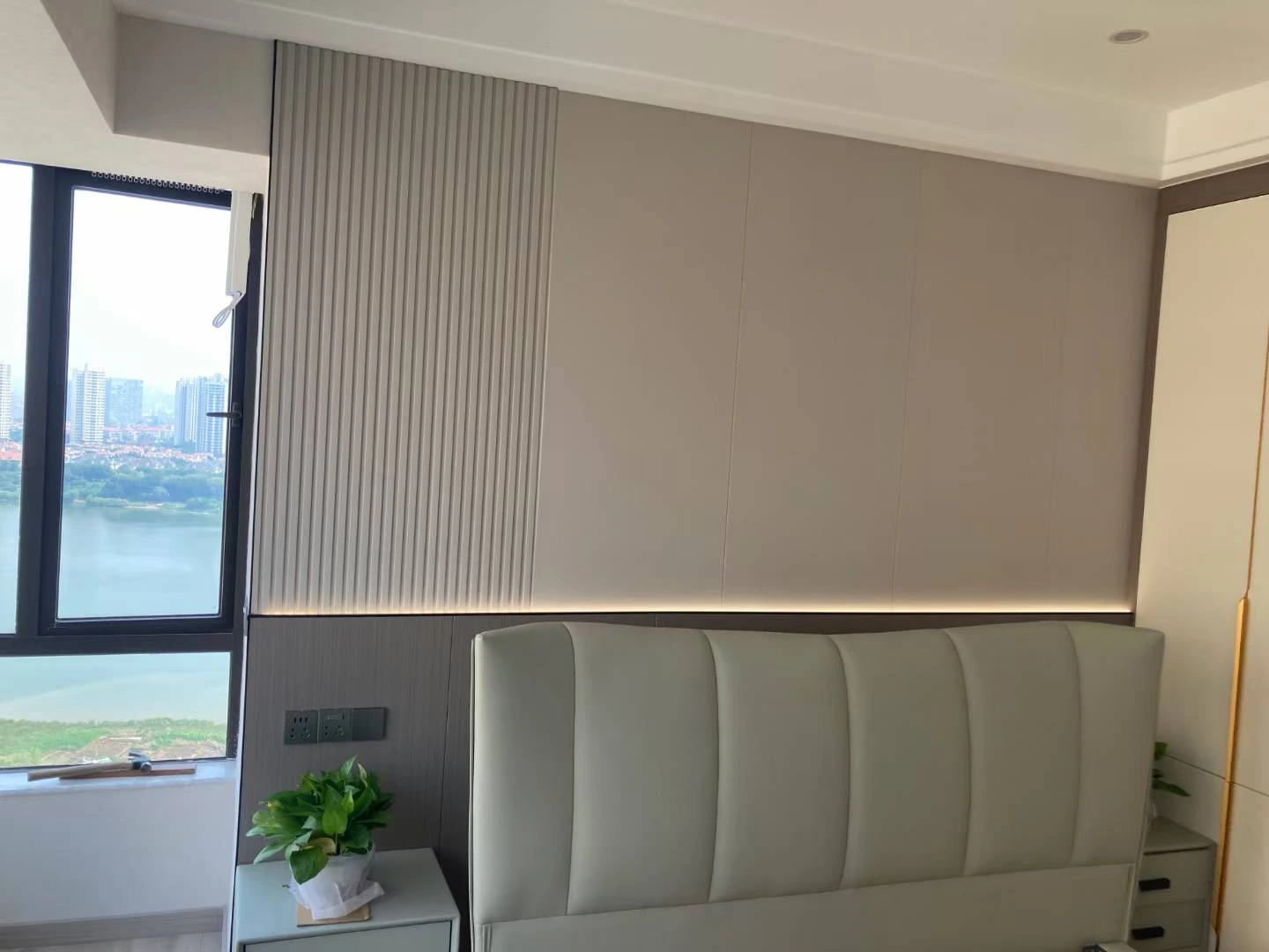 Bedroom feature wall with fluted panels and fabric-finish boards
